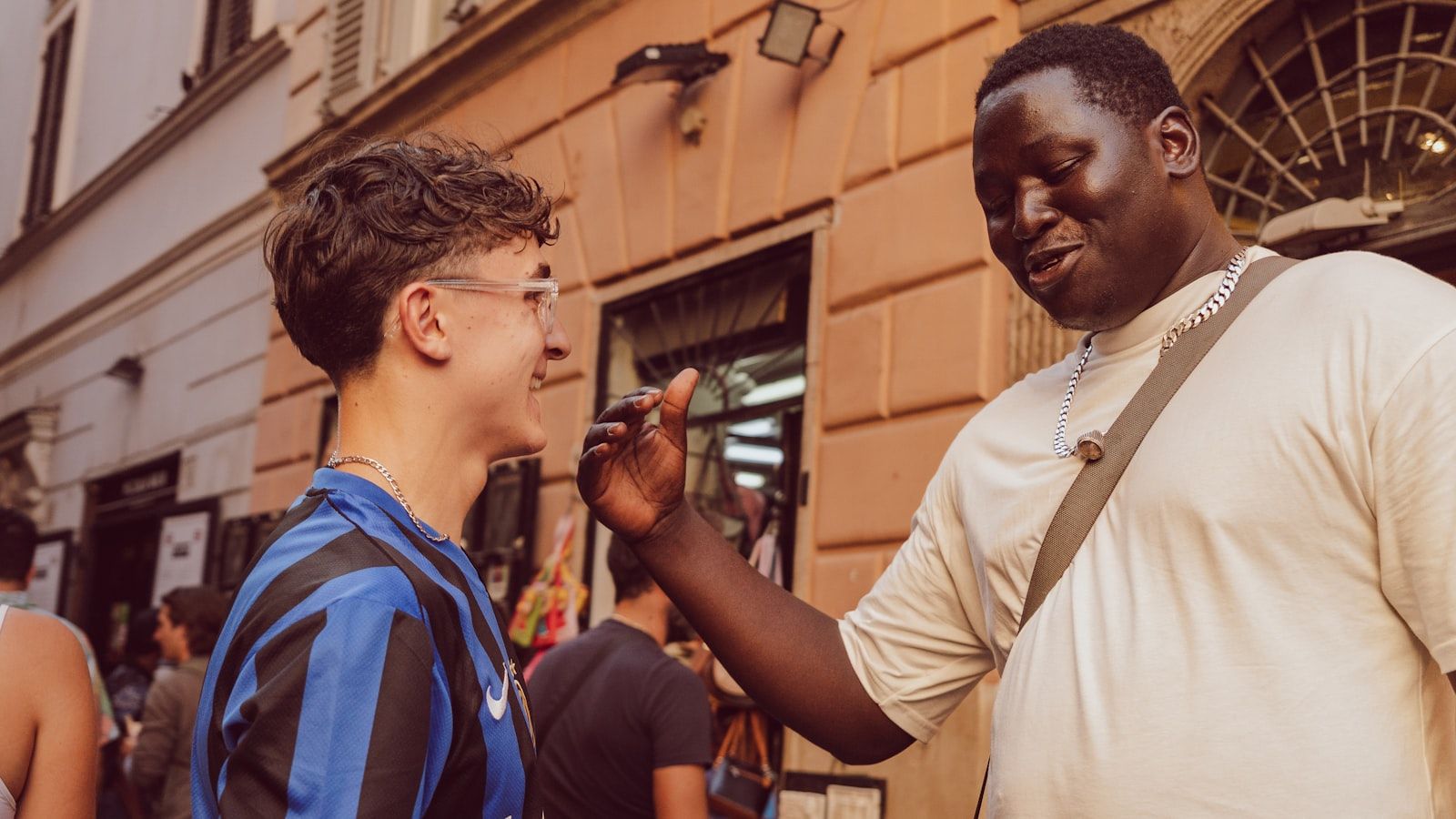 Two people having an animated face-to-face conversation on a city street